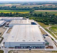 Logistics warehouses and halls in Bratislava - Devín surrounded by greenery and roads.