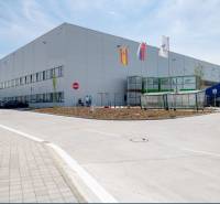Exterior of warehouses and halls in Bratislava - Devín with parking and a cargo truck.