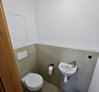 Bathroom with toilet, sink, and toilet paper holder in a 3-room apartment.