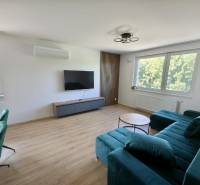 Living room with a television, sofa set, and table in a 3-room apartment.