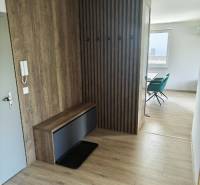 A hallway in a 3-room apartment with wooden paneling and a built-in wardrobe.