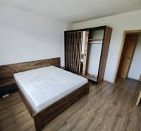 A bedroom in a 3-room apartment with light furniture and a double bed.