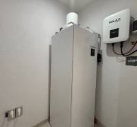 Equipment in the technical room of a family house with a Hyundai heat pump and a Solax unit.