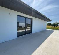 A family house in Podlužany with a spacious terrace and large glass doors.