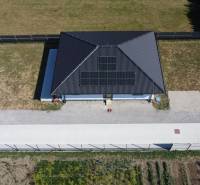 A family house in Podlužany with solar panels and a spacious garden.