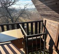 A balcony with wooden cladding and a view of nature, ideal for recreational properties.