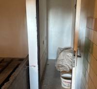 A narrow space with a metal bucket and construction material for recreational purposes and land.