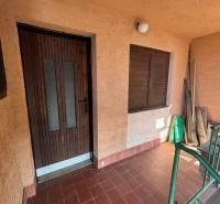 Wooden doors and a wall on the porch, ideal for recreational properties and relaxation.