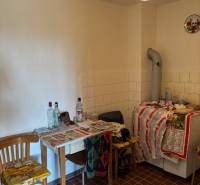 Old kitchen, tables and chairs with bottles, tiles, light, suitable for recreational properties.