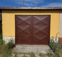 Brown garage on Záhradná Street in Svit with plants around.