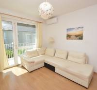 Bright living room with a white sofa in a 2-room apartment.