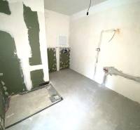 The interior of an unfinished 2-room apartment with prepared wiring on the walls.