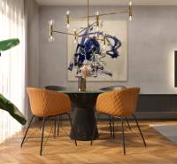 Dining area with orange chairs and decoration in a 2-room apartment.