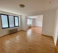 Interior with wooden flooring and large windows in a family house.
