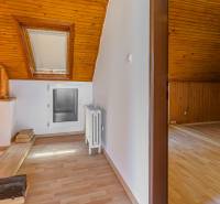 Attic space with wooden beams and a skylight in a family house.