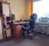 Room in a family house with keyboards, a desk, and a wardrobe.
