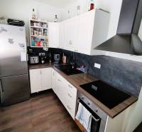 A kitchen in a 2-room apartment, equipped with appliances and storage space.