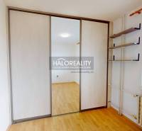 An apartment with sliding doors, storage space, and plenty of natural light.