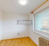 A room with a floating floor and a large window, ideal for a studio apartment, bright.