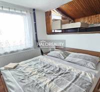 A bedroom in a family house with a single bed and an attic section with an additional bed.