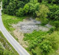 A residential plot in Selce with a road and greenery in a picturesque setting.
