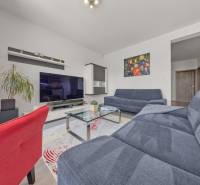 Living room in a 4-room apartment with a television, sofas, and interior decorations.