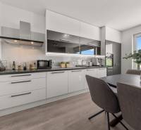 Kitchen in a 4-room apartment with a dining table and modern equipment.