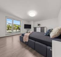 Bedroom in a 4-room apartment with a double bed and terrace doors.
