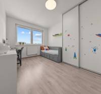 Children's room in a 4-room apartment with a bed, desk, and cabinet with space motifs.
