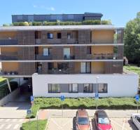 Residential complex on Yellow Street in Bratislava-Petržalka with parking spaces and greenery.