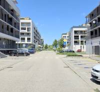 Žltá Street in Bratislava - Petržalka with modern apartment buildings and a parking lot.