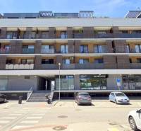 Apartment building on Žltá Street in the Bratislava - Petržalka area with parking in front of the building.