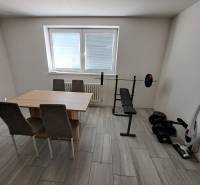 Dining room in a family house with fitness elements and a table with chairs.