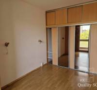 A spacious room with a built-in wardrobe in a 4-room apartment, with wooden flooring.