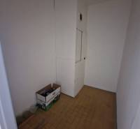 A small room with boxes and white walls in a 4-room apartment.