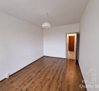 A room with a light wooden floor decor in a 4-room apartment, white walls.