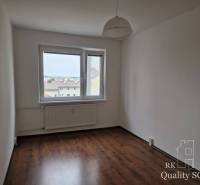A room in a 4-room apartment with laminate flooring and a simple pendant lamp.