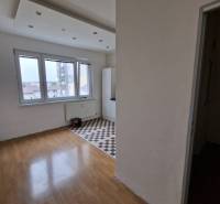 A bright room with parquet floors and checkerboard tiles in a 4-room apartment.