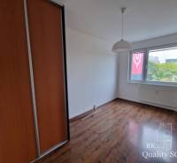 A room in a 4-room apartment with a wooden floor and a built-in wardrobe.