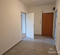 Entrance hall in a 4-room apartment with tiles and doors.