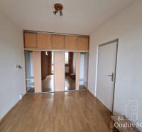 A spacious room with a wooden floor and a built-in wardrobe in a 4-room apartment.
