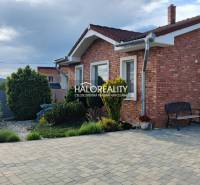 A family house in Kalinovo with a brick facade and a landscaped garden.