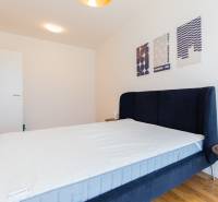 Bedroom with a bed and a nightstand in a 3-room apartment.