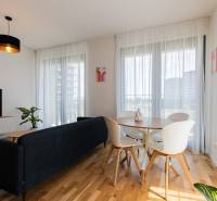 Living room in a 3-room apartment with a sofa, television, and dining table.