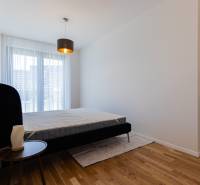 Bedroom with a gray bed and a window in a 3-room apartment.