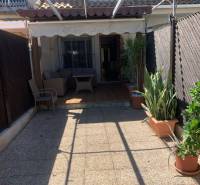 Terrace of a family house in Santiago de la Ribera with seating and greenery.