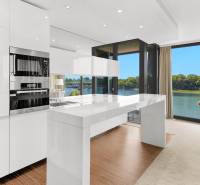 Kitchen in a 3-room apartment with a view of the river and a dining table.