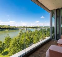A balcony with a view of the river and bridge in a 3-room apartment.