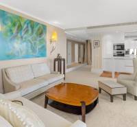A stylish living room with abstract art in a 3-room apartment, comfortable sofa and armchair.