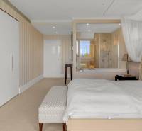 A bedroom with a canopy bed and a built-in wardrobe in a 3-room apartment.